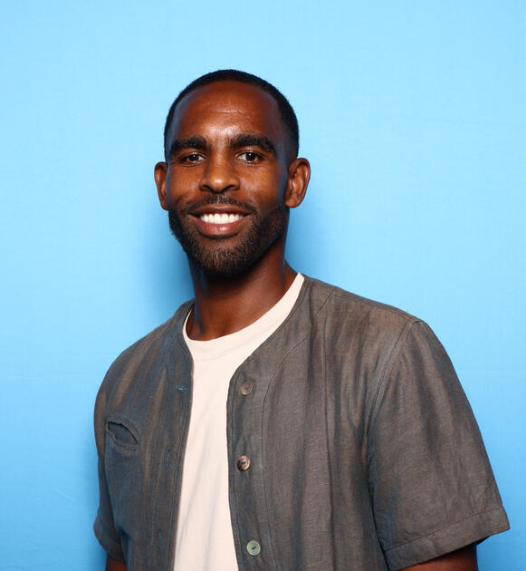 Jordan Brown headshot with light blue background